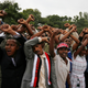 Demonstrators chant slogans while flashing the Oromo protest gesture during Irreecha, the thanksgiving festival of the Oromo people, in Bishoftu town, Oromia region, Ethiopia